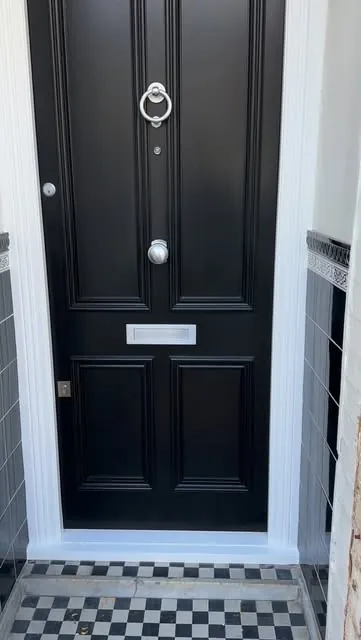 Panelled black entrance door