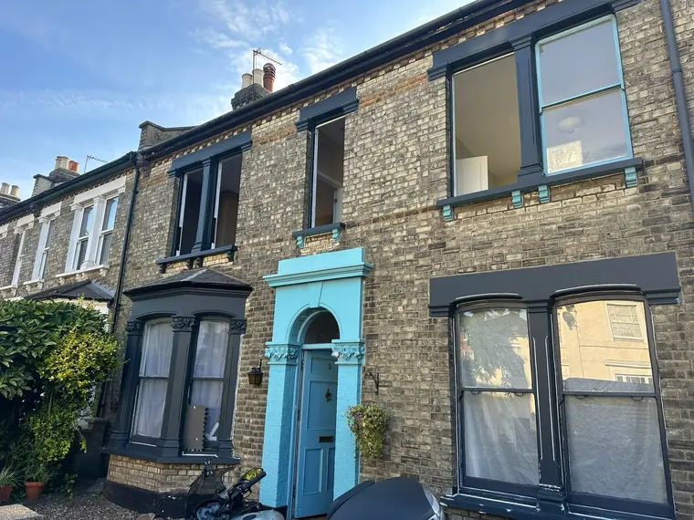Dark-painted windows and full front elevation