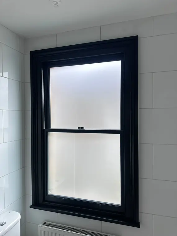 Dark-painted privacy-glazed sash