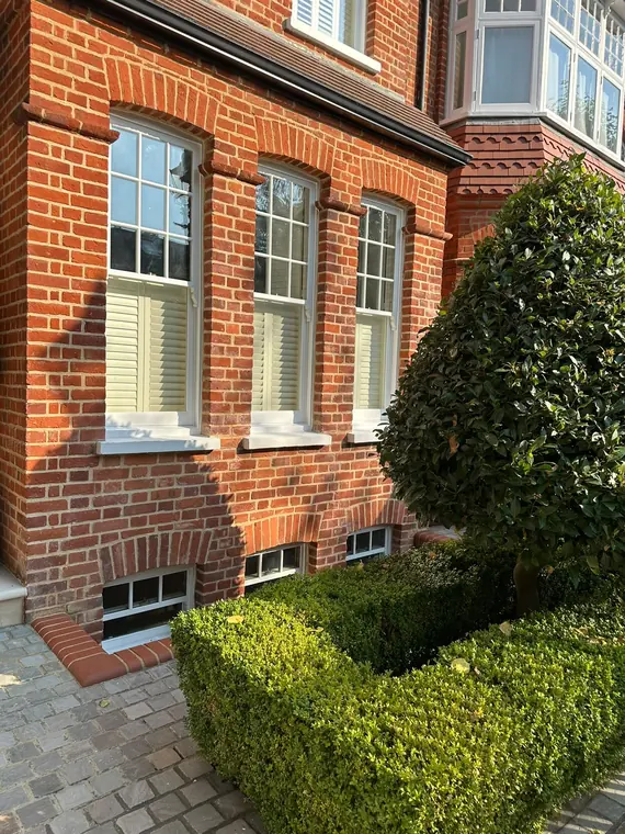 Cafe-style shutters across three sash openings