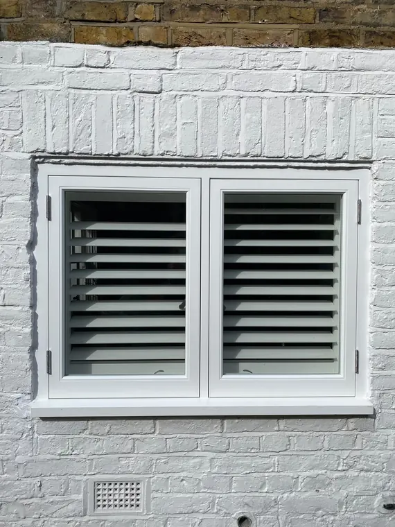 Shutters fitted behind painted timber casements