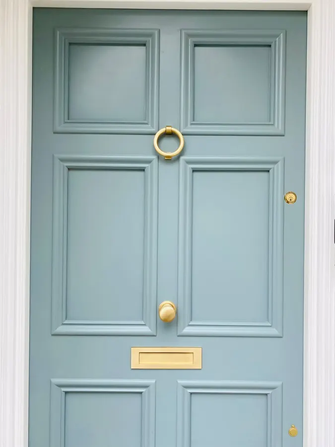 Panelled entrance door with brass hardware
