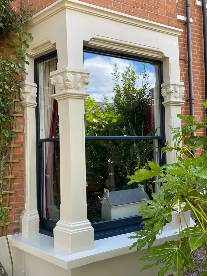Dark-painted sash in an ornate bay